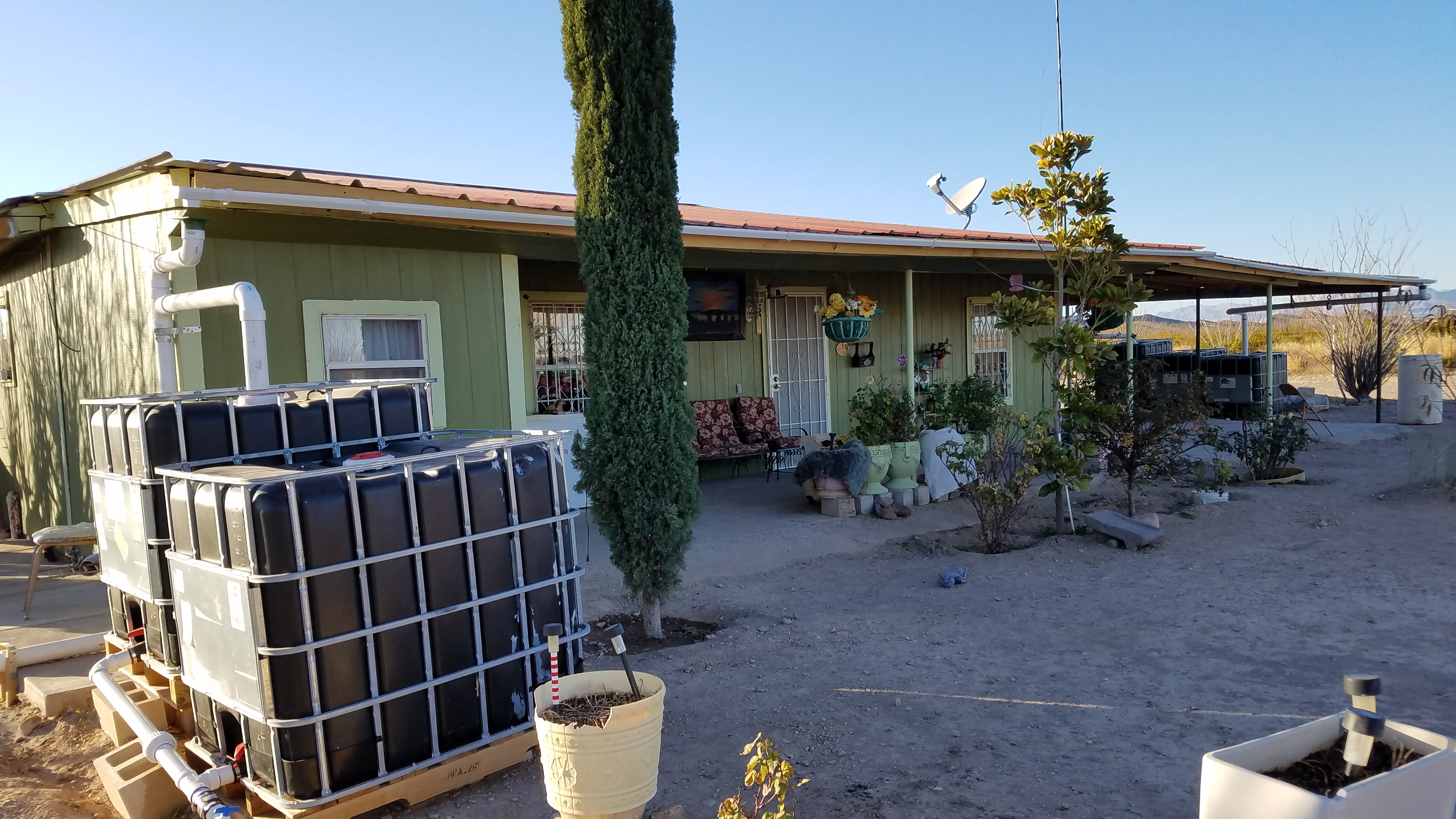 View of the demonstration rainwater harvesting system set-up in the rear of the home.